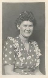 [A Woman in a Daisy-covered Dress and Matching Earrings]