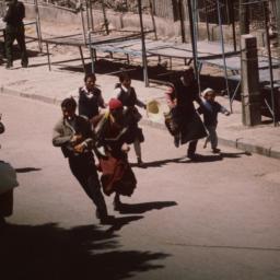 Tibetans running past deser...