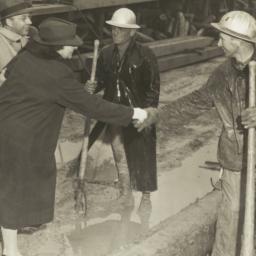 Frances Perkins shakes hand...