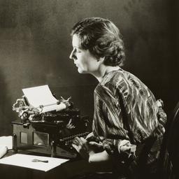 Woman Writing on Typewriter