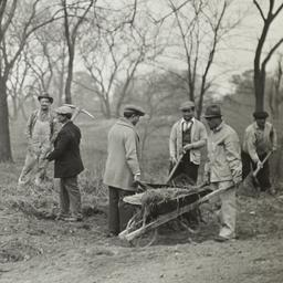 Men Clearing Area with Whee...